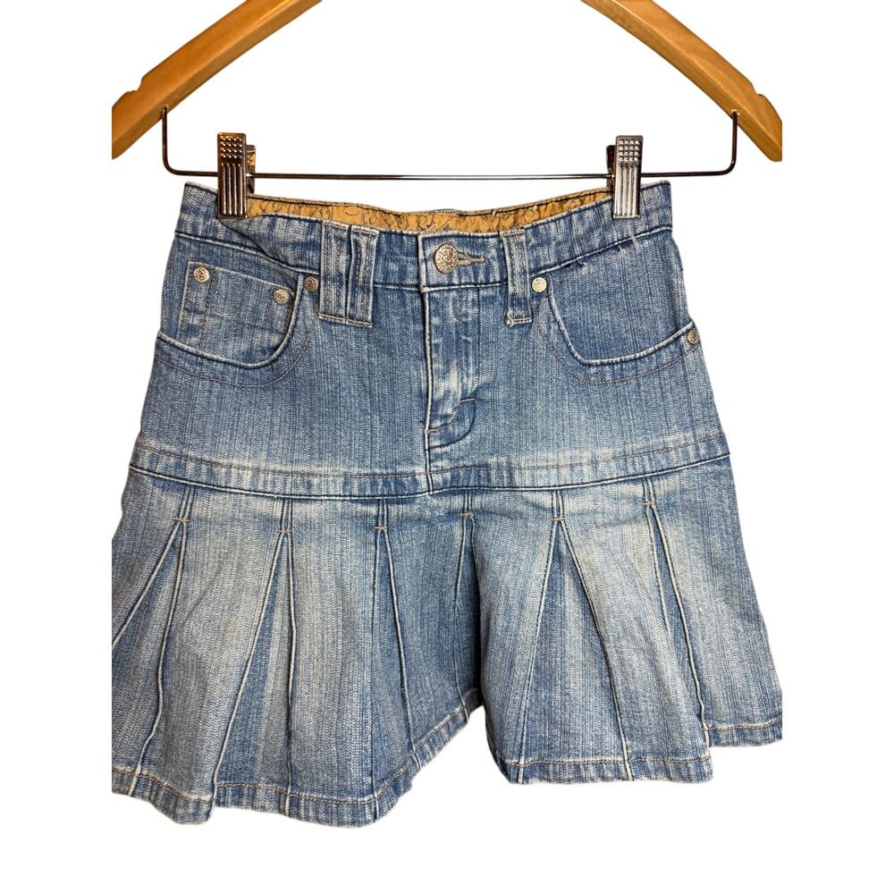 mudd denim pleated miniskirt with attached shorts, reminiscent of Y2K fashion. 